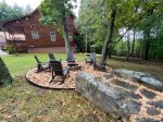 Outdoor fire pit with Adirondack seating for 6 and lighting for evening enjoyment